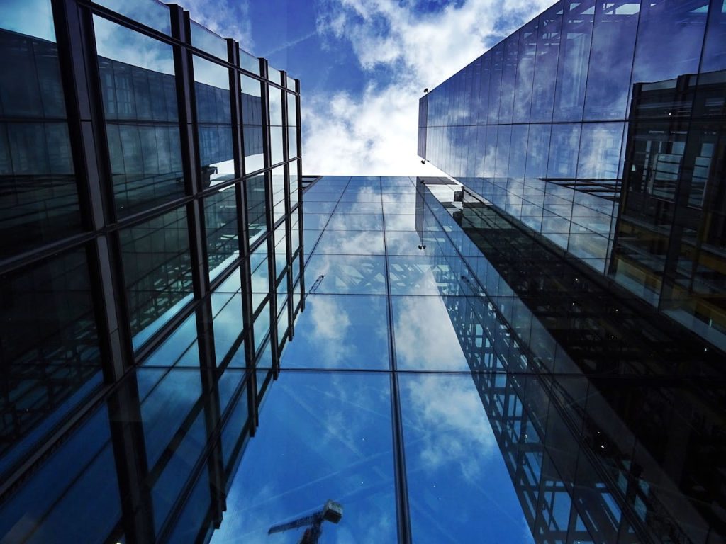 pexels-photo-443399 Perspective view of modern skyscraper facades with glass reflections of clouds and sky.