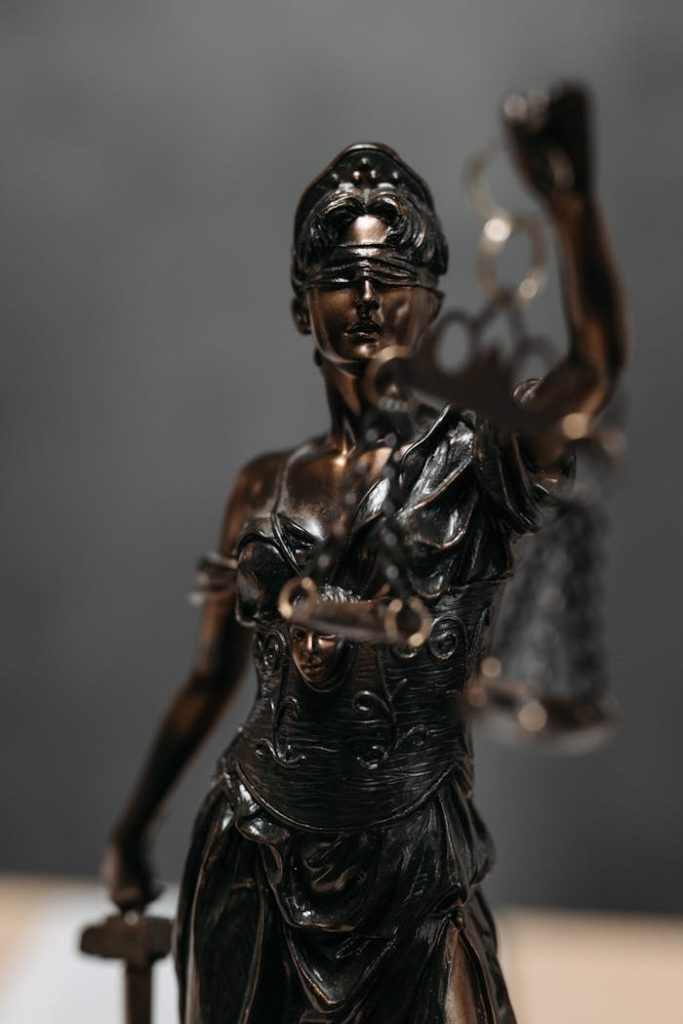 pexels-photo-8112195 Detailed bronze statue of Lady Justice with scales, symbolizing law and justice.
